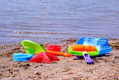 Multi colored toy on sand at beach