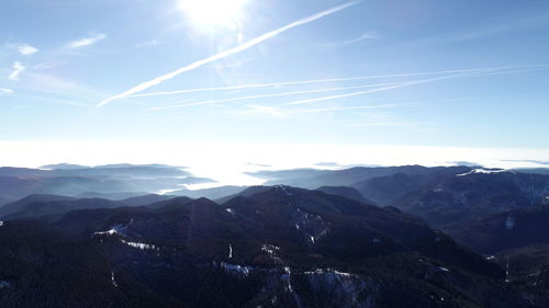 Scenic view of mountains against sky on sunny day