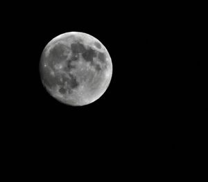 Low angle view of moon against clear sky at night