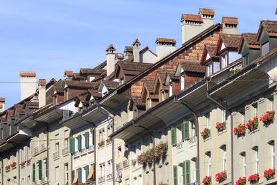 Low angle view of buildings in town against sky