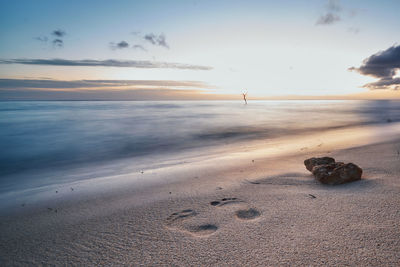 Scenic view of beach against sky during sunset