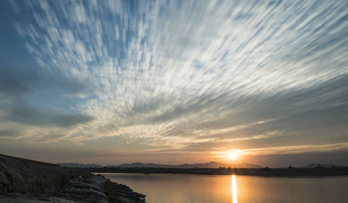 Scenic view of lake against sky during sunset