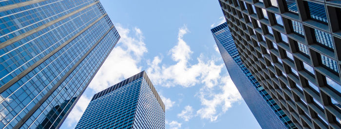 Low angle view of modern buildings against sky in city