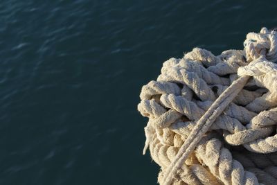 Close-up of rope tied to sea