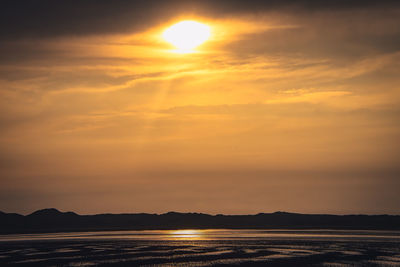 Scenic view of sea against romantic sky at sunset