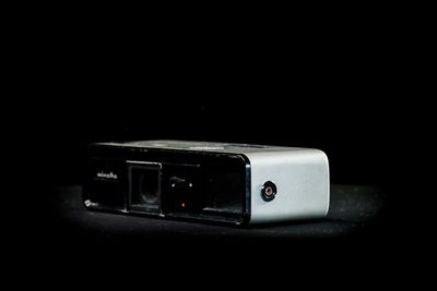 Close-up of vintage car on table against black background