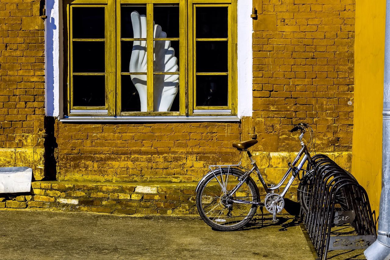 building exterior, yellow, architecture, built structure, bicycle, outdoors, no people, night