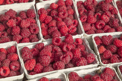 High angle view of raspberries in container for sale at market