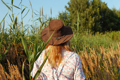 Rear view of woman standing on field