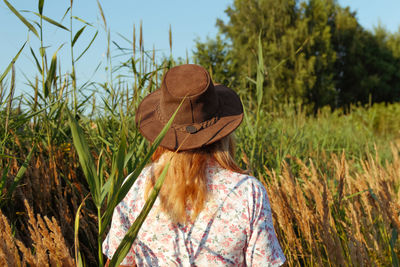 Woman near reed and pampas grass. youth, wellness romantic and lifestyle concept. 40s  back view. 