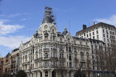 Low angle view of building against cloudy sky