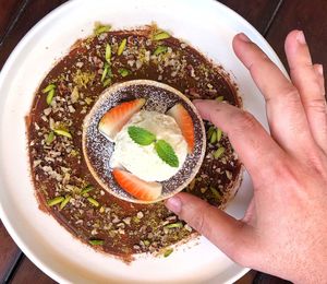 High angle view of hand holding bowl of soup