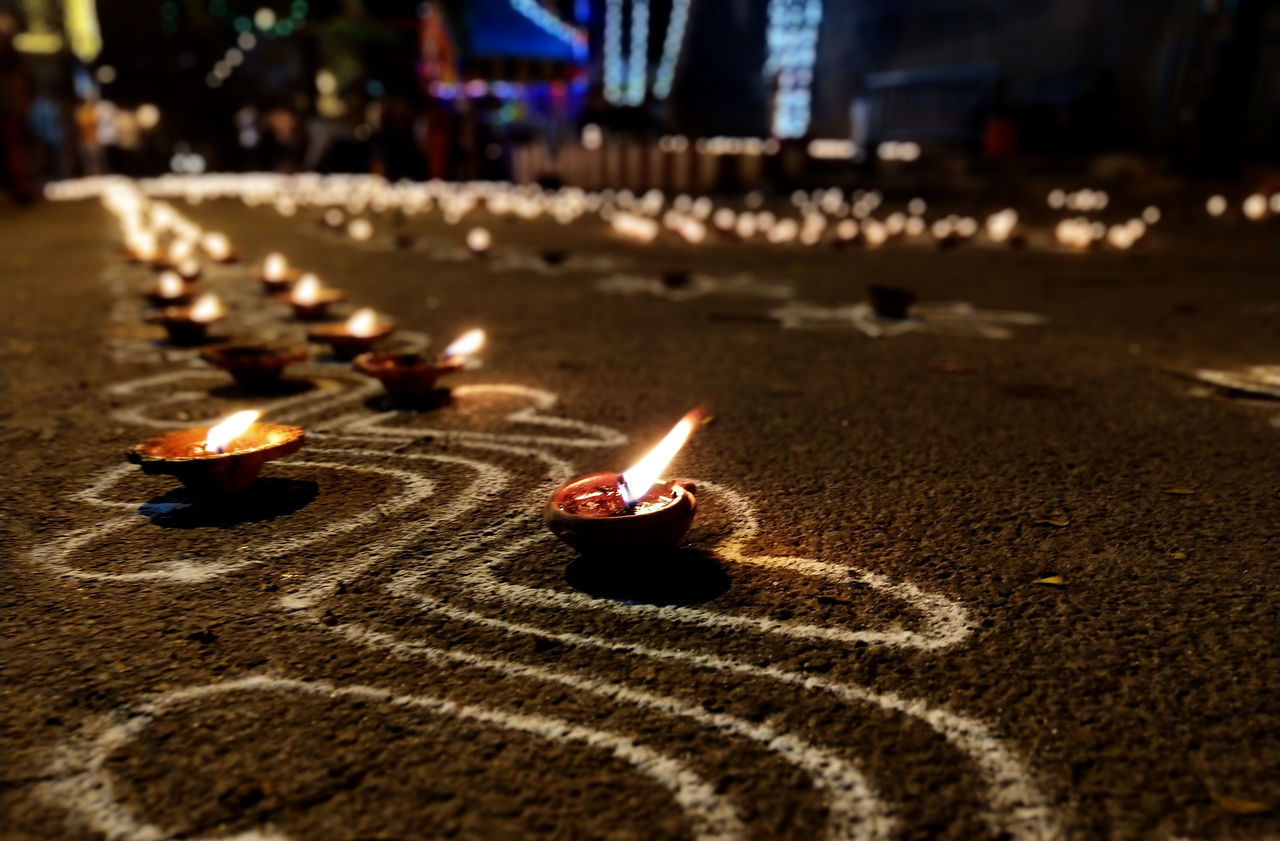 CLOSE-UP OF BURNING CANDLES ON FIRE