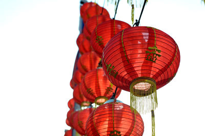 Low angle view of illuminated lanterns against clear sky