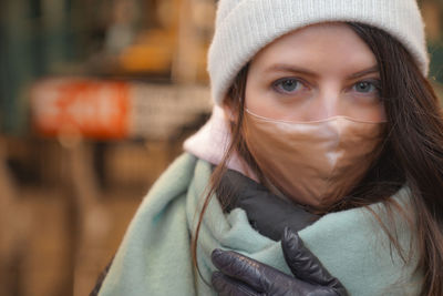 Portrait of woman wearing mask and warm clothing