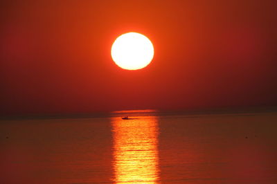 Scenic view of sea against romantic sky at sunset