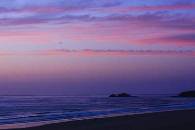 Scenic view of sea against sky at sunset