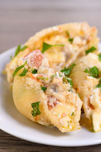 Pasta conchiglie stuffed with tender chicken pieces, mushrooms and vegetables in a rich creamy sauce