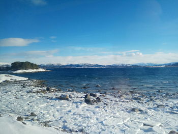 Scenic view of sea against blue sky