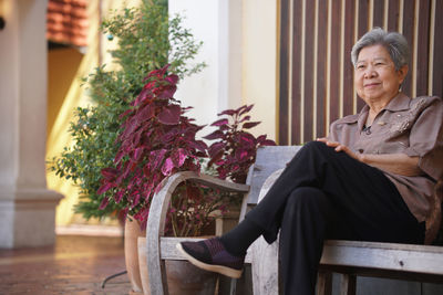 Portrait of young man sitting on bench