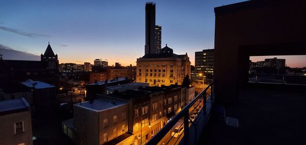 High angle view of buildings in city at dusk