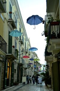 Street amidst buildings in city against sky