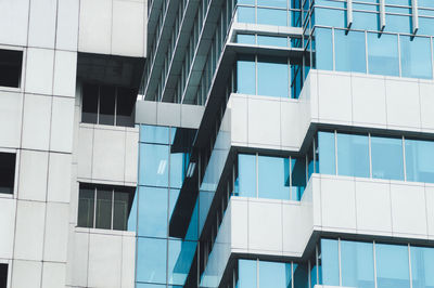 Low angle view of modern glass building in city