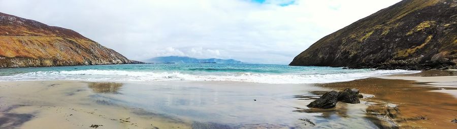 Scenic view of sea against cloudy sky