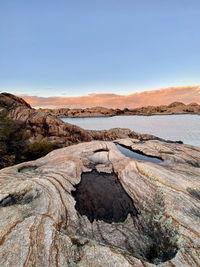 Scenic view of rocks against sky during sunset