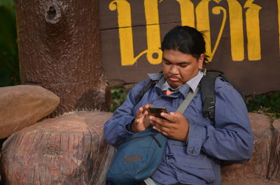Full length of man using mobile phone