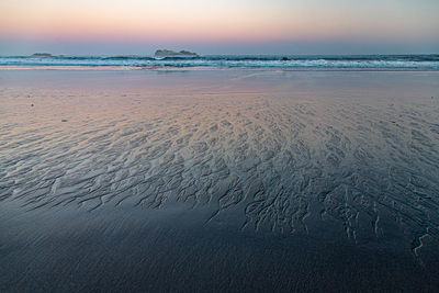 Scenic view of beach against sky during sunset