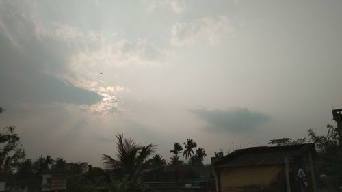 Panoramic view of building and trees against sky