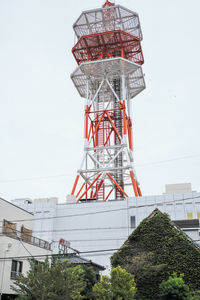 Low angle view of communications tower against sky