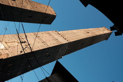 Low angle view of old building against clear blue sky