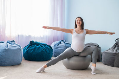 Side view of woman exercising at home