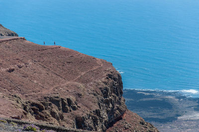 High angle view of rocks on shore against sea