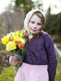 Girl dressed up as easter witch with tulips