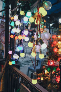 Close-up of illuminated light bulbs hanging on tree