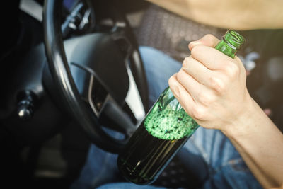 Cropped hand of woman holding drink