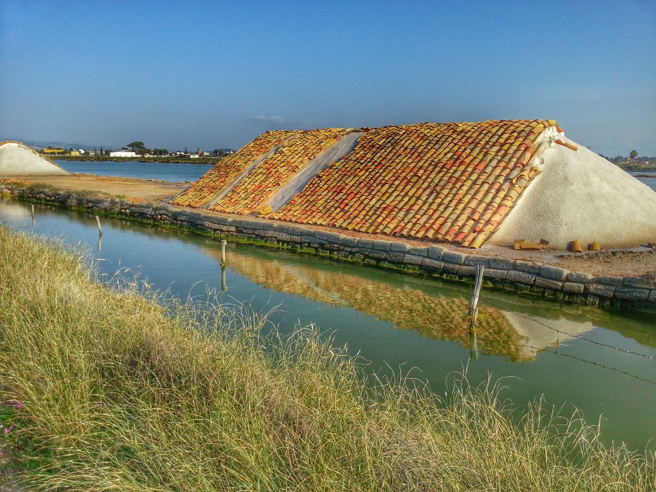 water, architecture, built structure, clear sky, building exterior, reflection, blue, copy space, lake, travel destinations, tranquility, famous place, waterfront, day, nature, river, outdoors, sea, history, sky