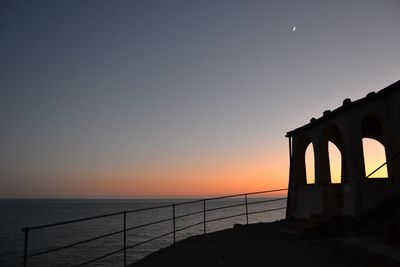 Scenic view of sea against clear sky during sunset