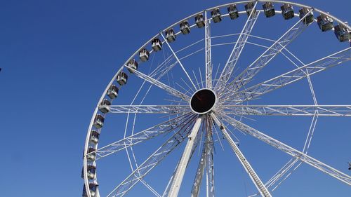 Low angle view of ferris wheel against sky