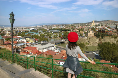 Rear view of woman looking at cityscape