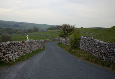 Road amidst landscape against sky