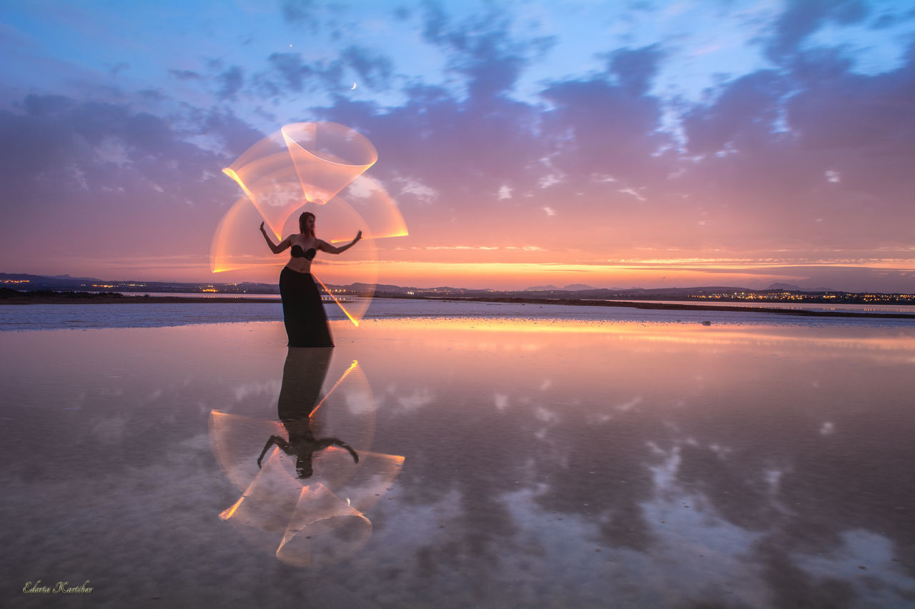 WOMAN ON BEACH DURING SUNSET