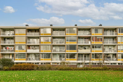 Houses on field against sky