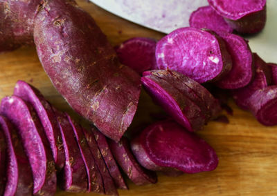 Close up of purple petals on cutting board