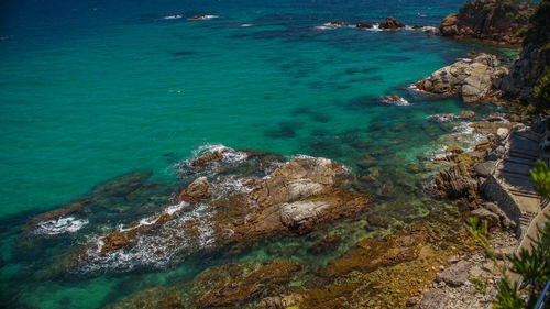 High angle view of rocks at sea shore