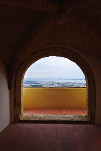 View of sea seen through arch window