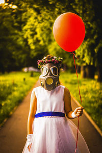 Midsection of person holding balloons